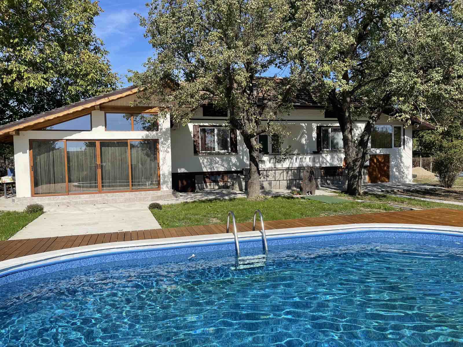 Villa facade with yard and pool